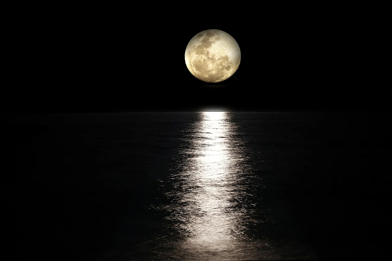 Full moon shining over the sea at night