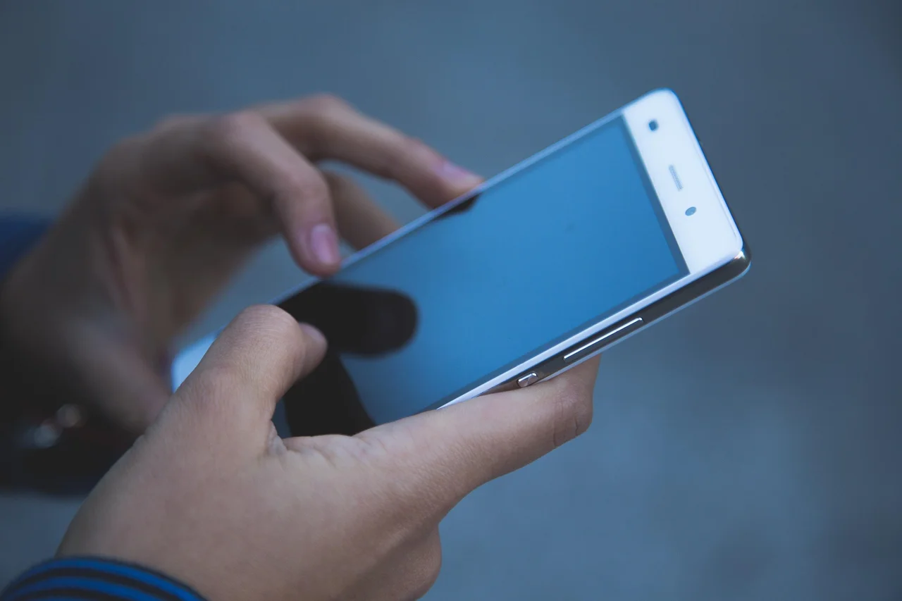 Hands interact with a smartphone