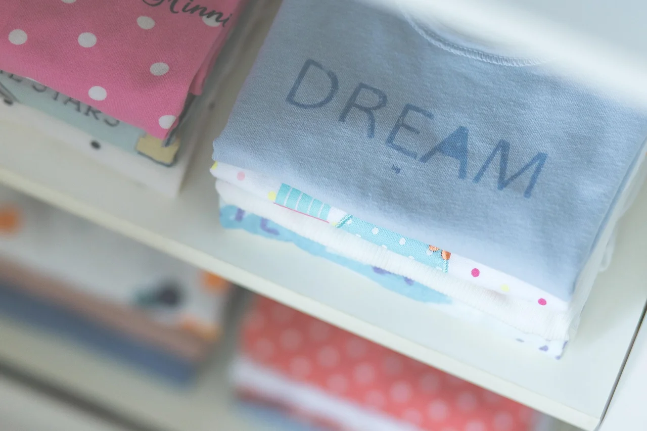 Folded baby clothes in storage