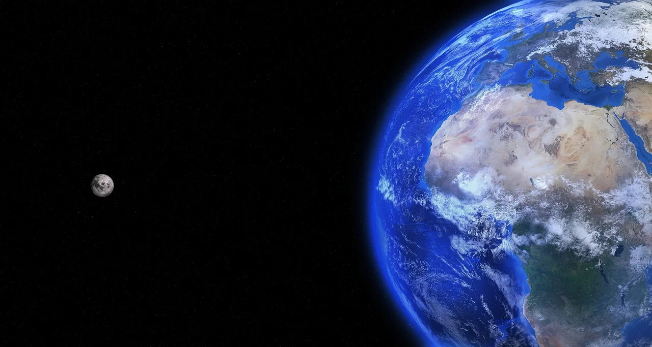 Planet Earth with the Moon beside it against the black backdrop of space